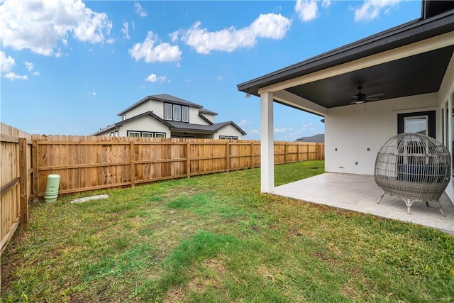 view of yard with a patio area and ceiling fan