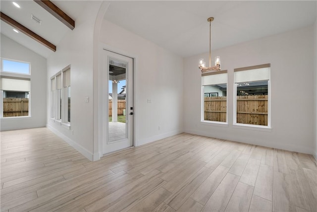 empty room featuring high vaulted ceiling, an inviting chandelier, beam ceiling, and light hardwood / wood-style floors