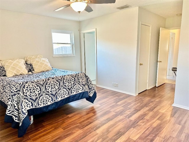 bedroom featuring hardwood / wood-style flooring and ceiling fan