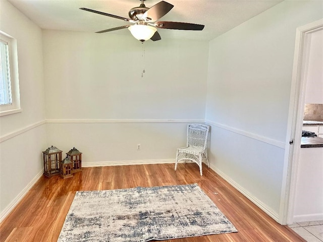 unfurnished room with ceiling fan and light wood-type flooring