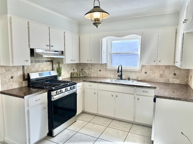 kitchen featuring white cabinetry, stainless steel gas range oven, sink, and backsplash