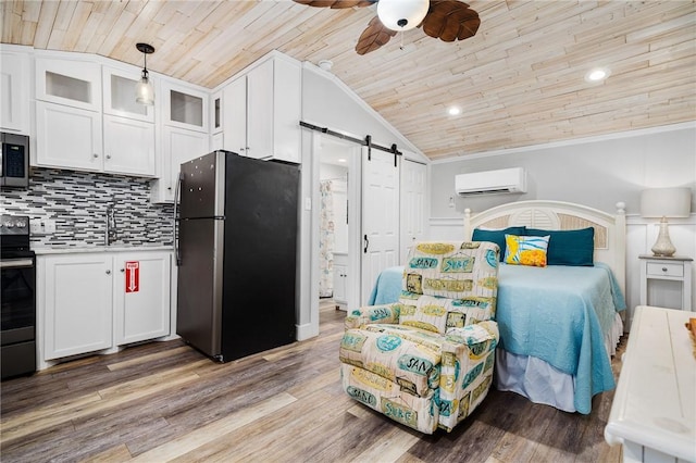 bedroom featuring a barn door, freestanding refrigerator, wood ceiling, an AC wall unit, and vaulted ceiling