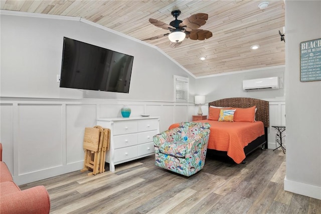 bedroom featuring lofted ceiling, a wall mounted AC, ornamental molding, wood ceiling, and wood finished floors