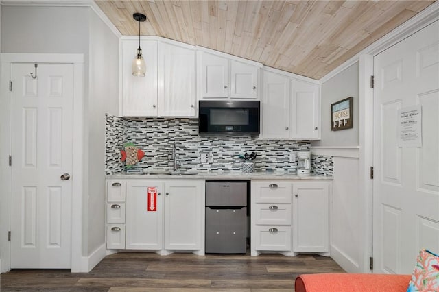 kitchen with pendant lighting, light countertops, a sink, and white cabinetry