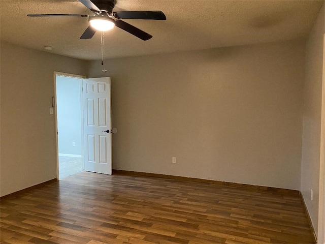 spare room with ceiling fan, dark hardwood / wood-style flooring, and a textured ceiling