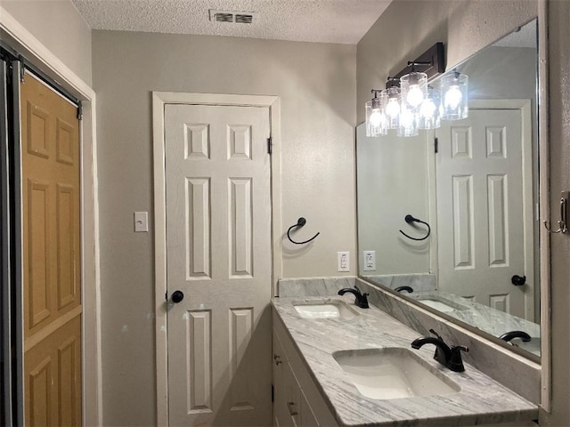 bathroom featuring vanity and a textured ceiling