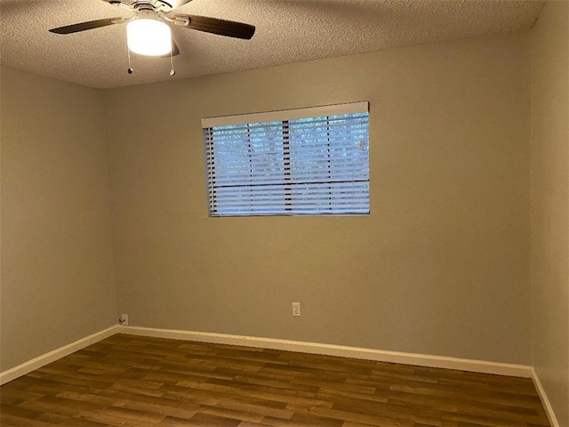 spare room featuring hardwood / wood-style flooring, ceiling fan, and a textured ceiling