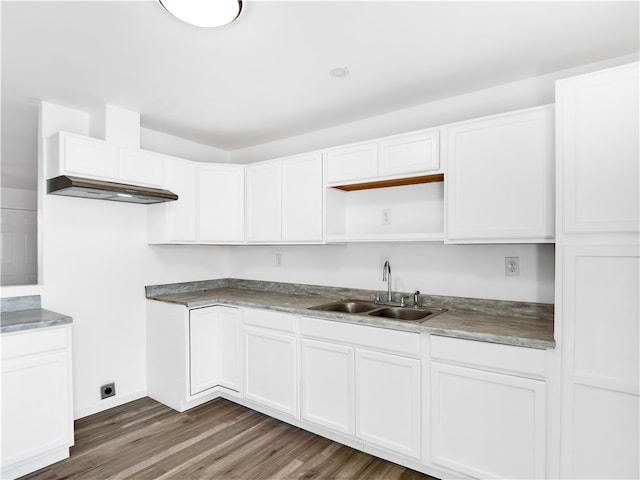 kitchen featuring dark hardwood / wood-style floors, white cabinetry, and sink