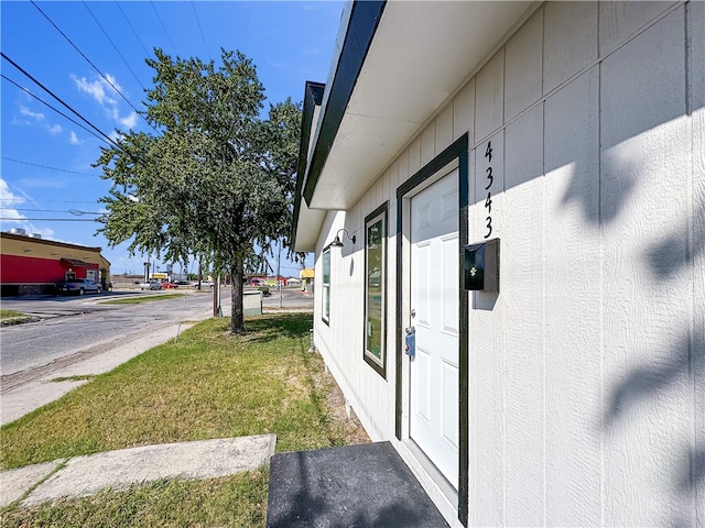 view of side of property with a yard