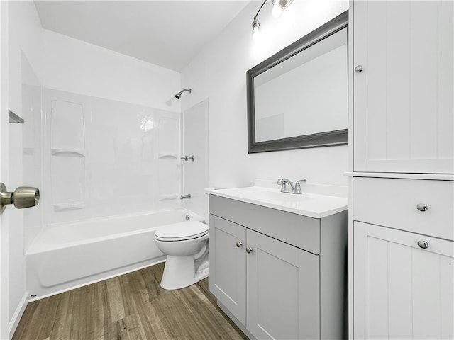 full bathroom with vanity, toilet, wood-type flooring, and bathing tub / shower combination