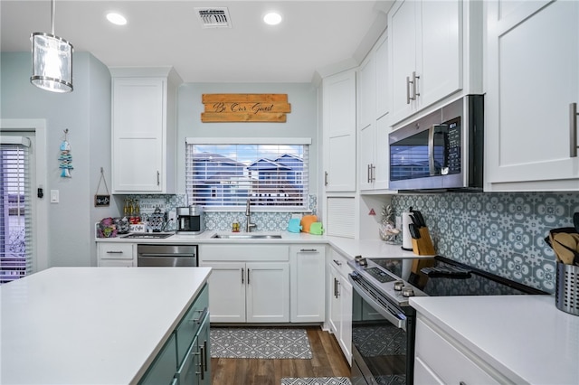 kitchen with white cabinets, appliances with stainless steel finishes, sink, and plenty of natural light