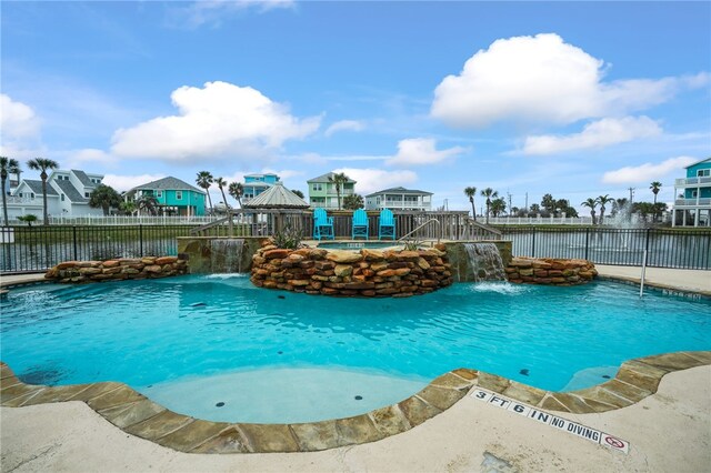 view of pool featuring a water view and pool water feature