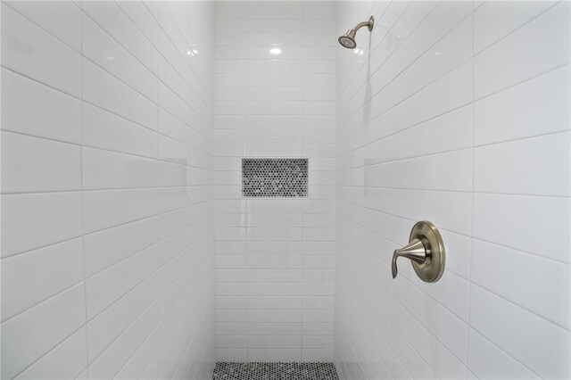 bathroom with a tile shower