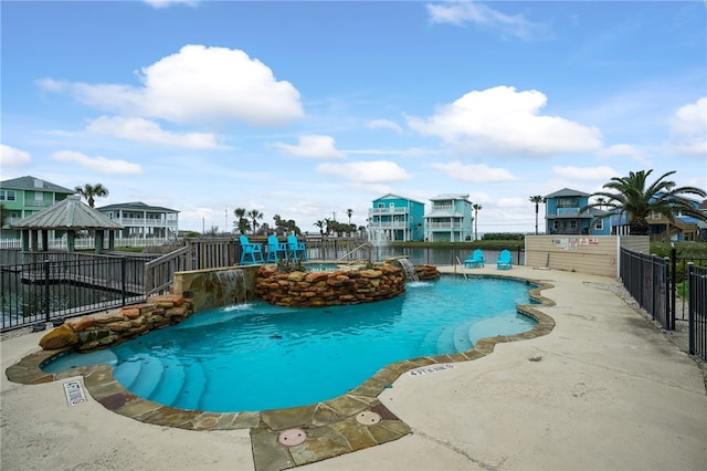 view of swimming pool with a gazebo and pool water feature