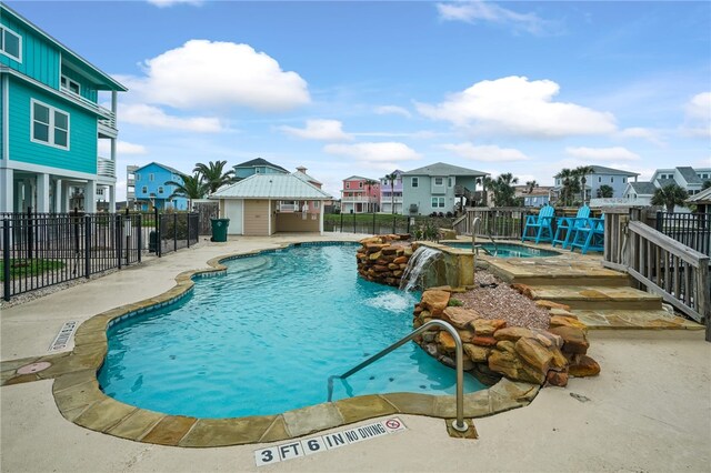 view of pool featuring pool water feature and a patio area