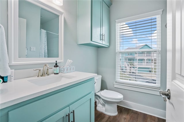 bathroom with hardwood / wood-style floors, vanity, toilet, and a shower with curtain