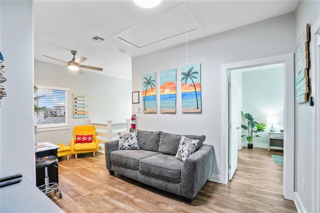 living room with wood-type flooring and ceiling fan