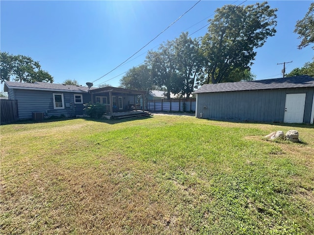 view of yard with an outdoor structure and central AC