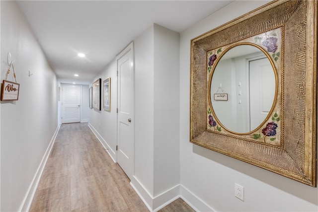 hallway with light hardwood / wood-style flooring