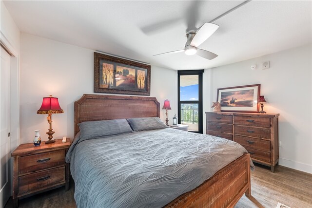 bedroom with wood-type flooring, ceiling fan, and a closet