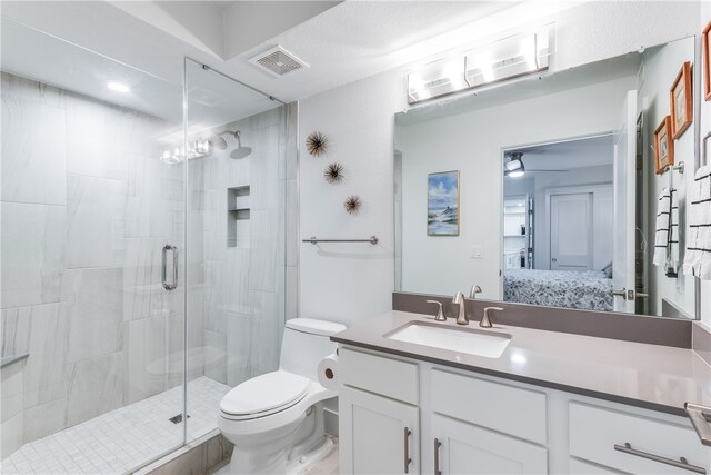 bathroom featuring vanity, ceiling fan, toilet, and a shower with shower door