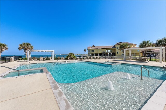 view of pool featuring a patio, a hot tub, and pool water feature