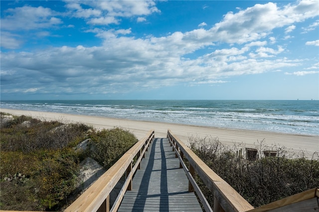 view of home's community featuring a water view and a view of the beach