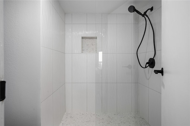 bathroom with tiled shower