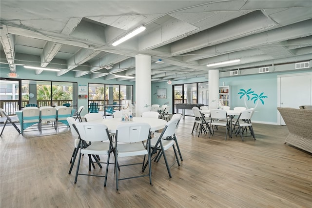 dining area with visible vents, baseboards, and wood finished floors