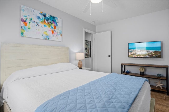 bedroom with ceiling fan and wood finished floors