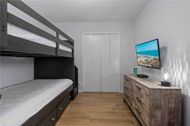 bedroom featuring wood finish floors and a closet