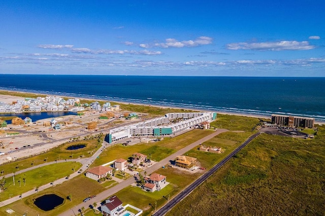 drone / aerial view featuring a water view and a beach view