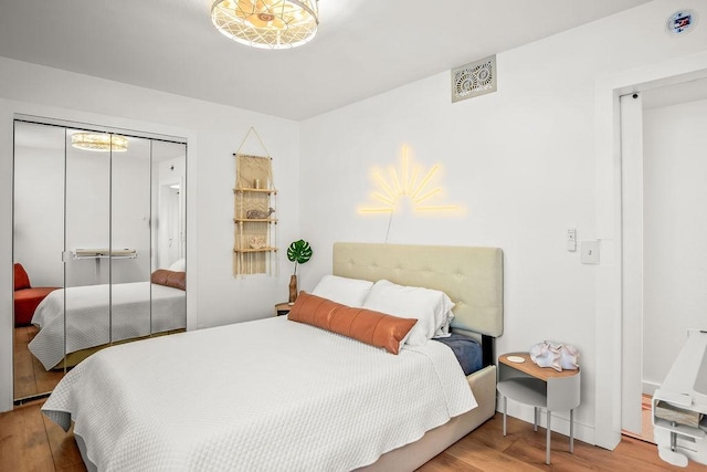 bedroom with wood-type flooring and a closet