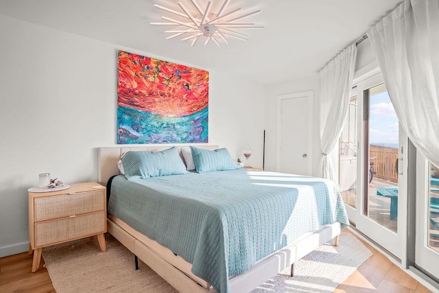 bedroom featuring access to exterior and light hardwood / wood-style floors