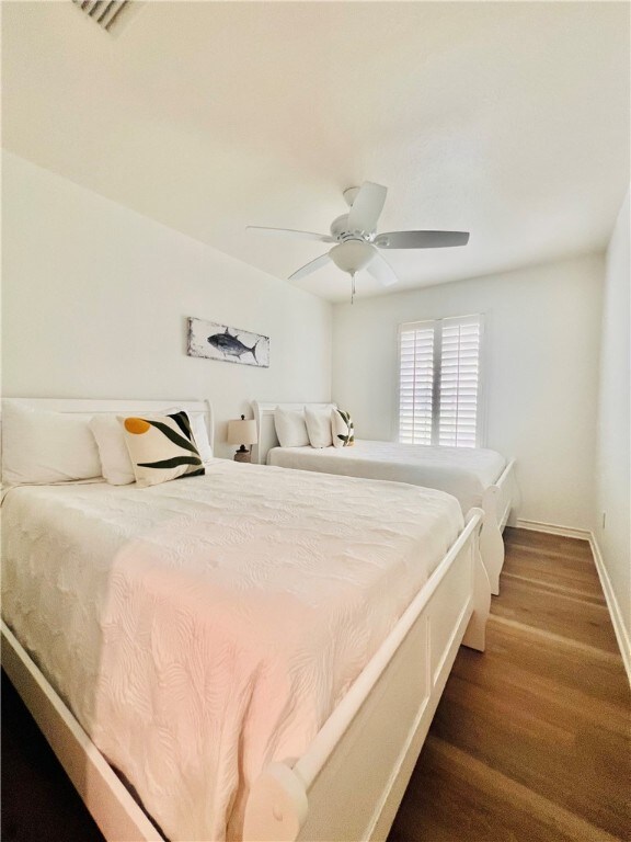 bedroom featuring ceiling fan and dark hardwood / wood-style floors