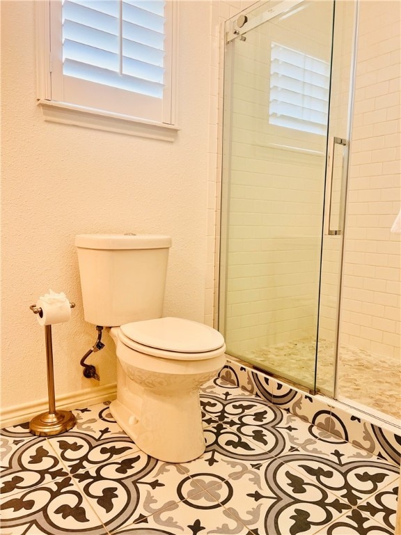 bathroom with walk in shower, tile patterned floors, and toilet