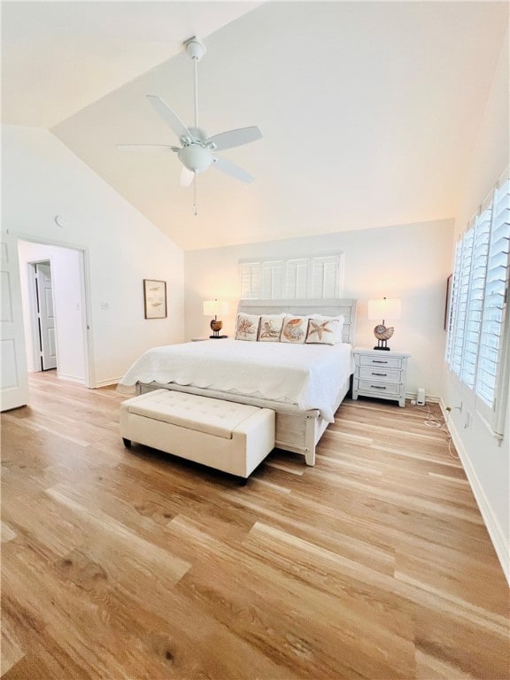 bedroom featuring ceiling fan, light hardwood / wood-style flooring, and high vaulted ceiling