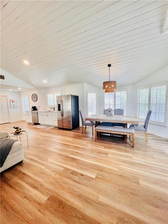 dining room with lofted ceiling, wood ceiling, and light hardwood / wood-style floors