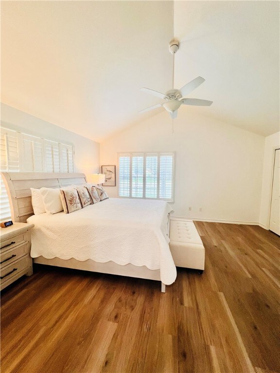 bedroom featuring vaulted ceiling, hardwood / wood-style flooring, and ceiling fan