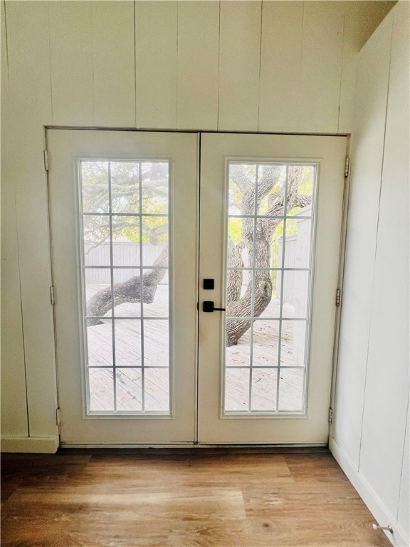 doorway with light wood-type flooring and french doors