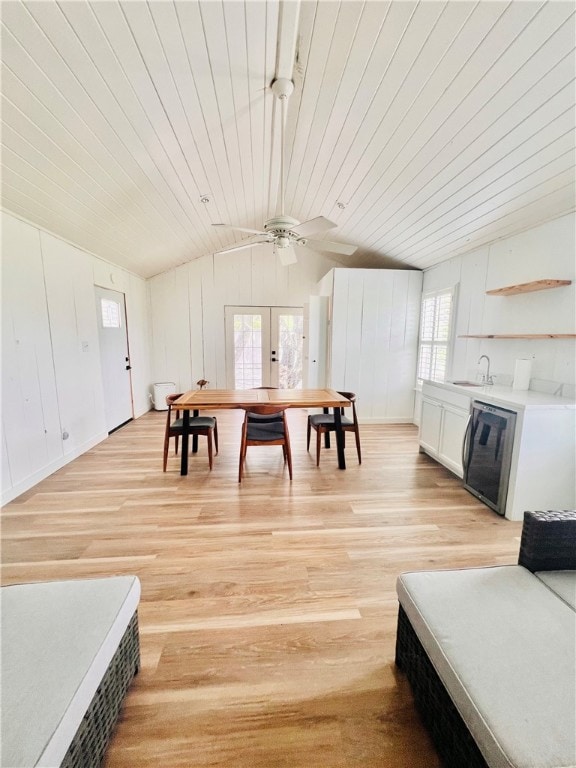 dining room featuring wooden ceiling, sink, light hardwood / wood-style flooring, and vaulted ceiling