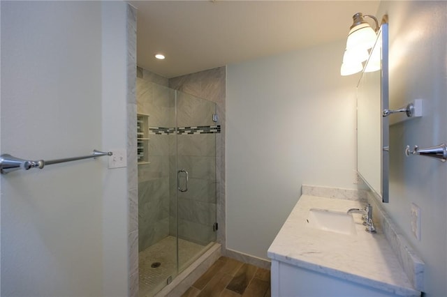 bathroom featuring vanity, hardwood / wood-style flooring, and walk in shower