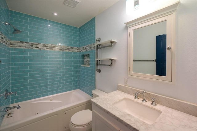 full bathroom featuring vanity, tiled shower / bath combo, and toilet