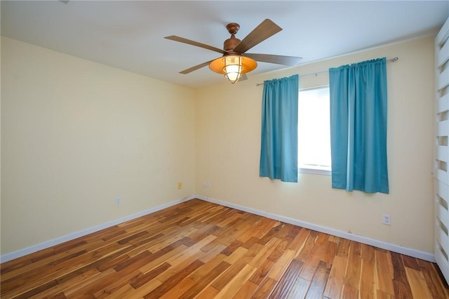 spare room featuring hardwood / wood-style floors and ceiling fan