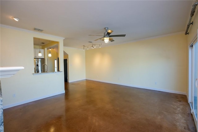 spare room featuring ceiling fan, ornamental molding, and sink