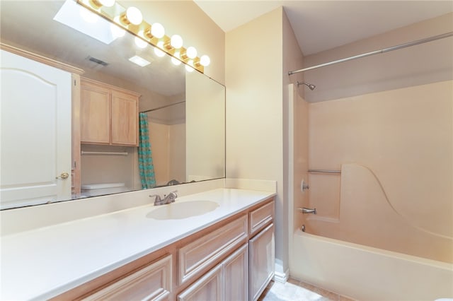 full bathroom featuring vanity, shower / tub combo, tile patterned flooring, toilet, and a skylight