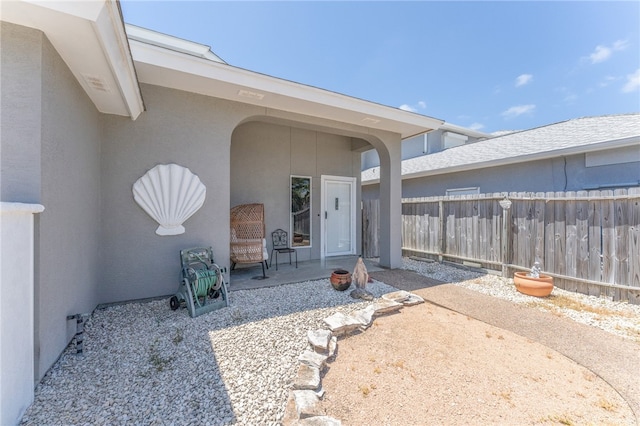 entrance to property featuring a patio area