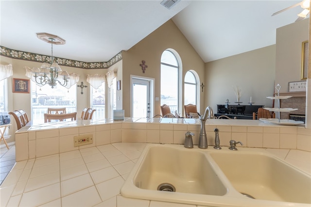 kitchen featuring pendant lighting, a chandelier, sink, and a healthy amount of sunlight