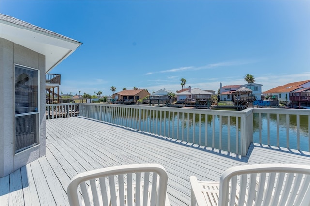 wooden terrace featuring a water view