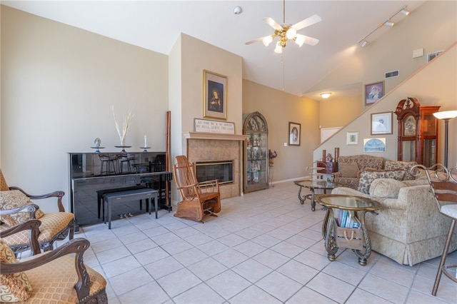 tiled living room featuring ceiling fan and high vaulted ceiling